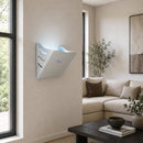 A white wall-mounted LED UV light fly trap  installed in a modern living room with a beige sofa, window, and dark coffee table.