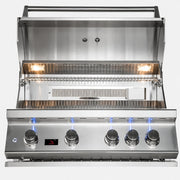 A stainless steel gas grill with the lid open, showing four control knobs, blue flame indicators, and interior grates on a white background.