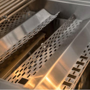 Close-up of stainless steel grill grates with elongated oval perforations inside a grill basket.