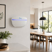 A white Awoco wall-mounted LED UV light fly trap shown in a modern, bright kitchen and dining room setting.