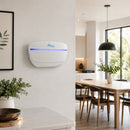 A white Awoco wall-mounted LED UV light fly trap shown in a modern, bright kitchen and dining room setting.